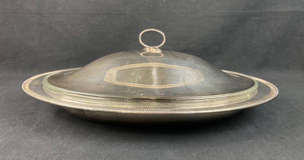 Gorham Silverplate Oval Serving Dish: This Gorham silver-plated oval serving dish showcases an elegant neoclassical design, featuring a gently curving form with sophisticated, understated adornments. The piece is styled with classic