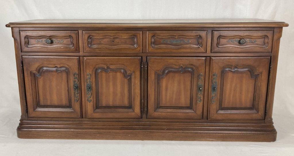 French Style Mahogany Credenza: A mid 20th century French style mahogany credenza featuring four drawers over four doors. It measures approximately 30 inches high x 68 inches wide x 19 inches deep. In good condition with some wear
