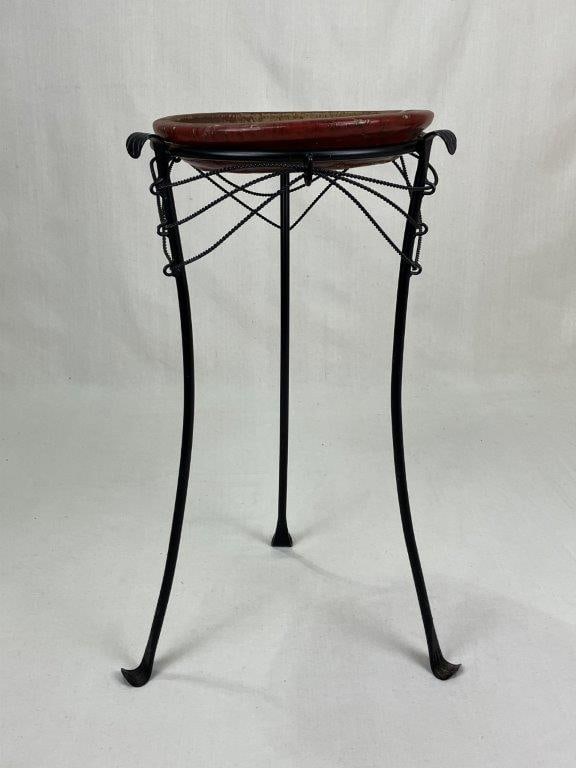 20th Century Iron Plant Stand: An elegant 20th century iron plant stand featuring a graceful tripod base with splayed legs terminating in stylized leaf feet, joined by ornamental twisted rope-like chains that provide both support a