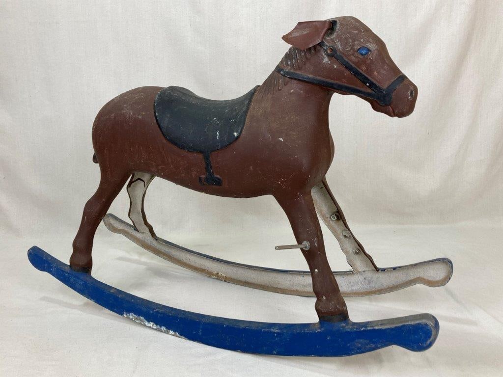 Vintage Cast Metal Rocking Horse: A vintage cast metal rocking horse featuring wonderful paint with a worn patina. It measures approximately 22Â½ inches high x 11 inches wide x 33 inches deep. Some loss to the paint