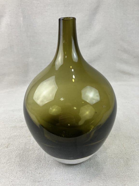 Mid-Century Modern Olive Green Art Glass Vase: Mid-century modern art glass vase features a beautifully hand-blown glass construction in a rich, sophisticated shade of olive green. Showcasing a graceful, fluid form with a smooth, tapering silhouet