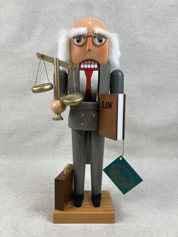 German Lawyer Nutcracker: A whimsical polychromed figural German lawyer nutcracker with original tag indicating "Made in Germany." The nutcracker stands approximately 12 inches tall. In good condition.