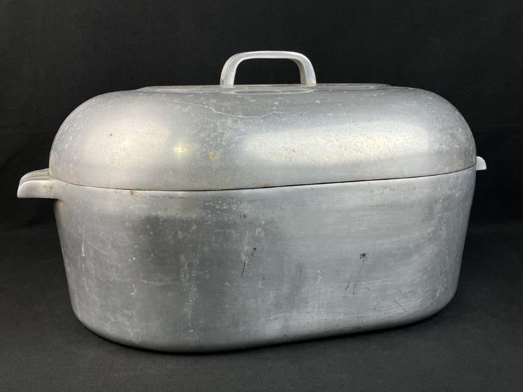 Wagner Ware Magnalite Aluminum Roaster: This beautiful mid-century modern piece of cookware by Wagner Ware features a sleek, aerodynamic form crafted from their signature cast aluminum composition. The design is accented by distinctive