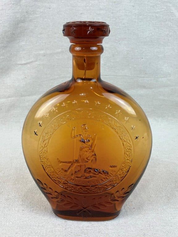 Virginia Commemorative Amber Glass Decanter: This handsome vintage amber glass decanter serves as a beautiful historic commemorative piece celebrating the Commonwealth of Virginia. The vessel features a prominent classical figural motif