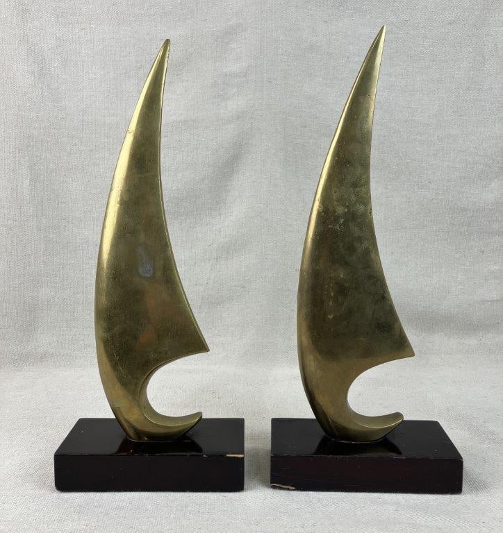Pair of Mid-Century Modernist Brass Sailboat Sculptures: Striking pair of modernist sculptures features abstracted sailboat forms beautifully crafted from brass and mounted onto small, elegant pedestals. Capturing the sleek lines and minimalist ethos of