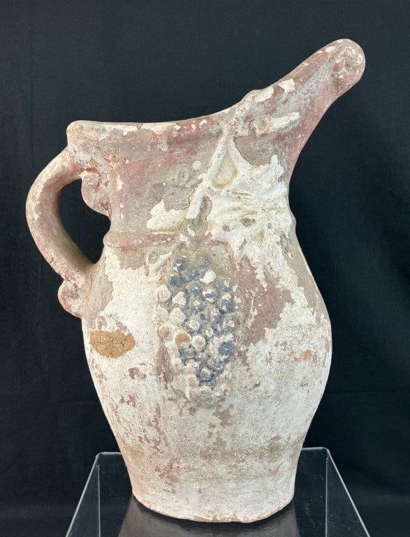 Terracotta Pitcher with Grape Motif: The vessel's tall, dramatic silhouette is elevated by a hand-painted finish and a beautifully sculpted, high-relief motif of cascading grape clusters and lush vine leaves that wrap gracefully around t