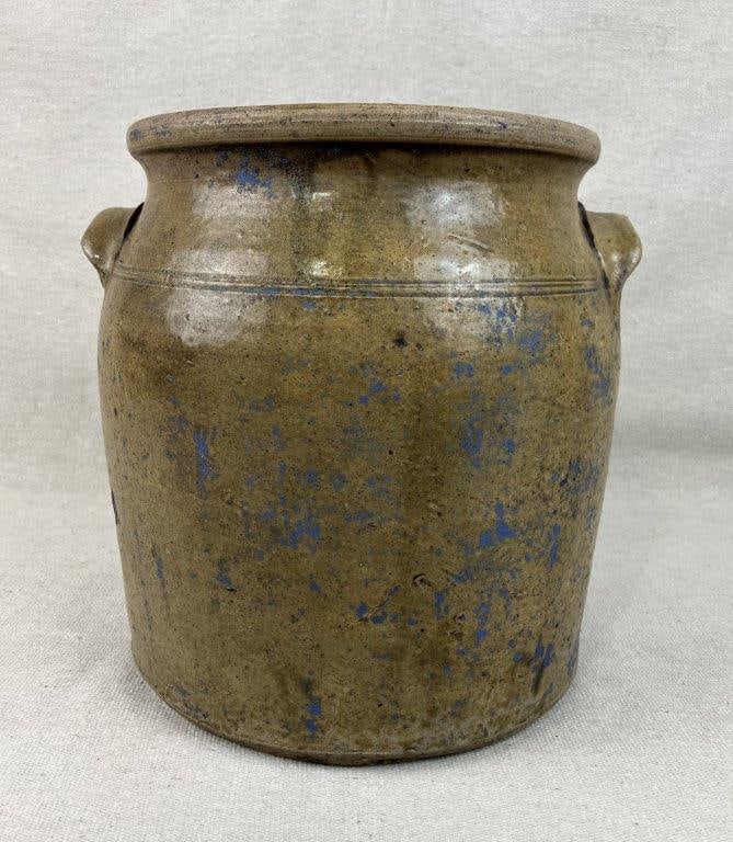 Glazed Stoneware Crock: Classic piece of early American utilitarian pottery features a timeless cylindrical form accentuated by a slightly curving shoulder and a pair of robust, hand-applied lug handles. The crock is subtly 