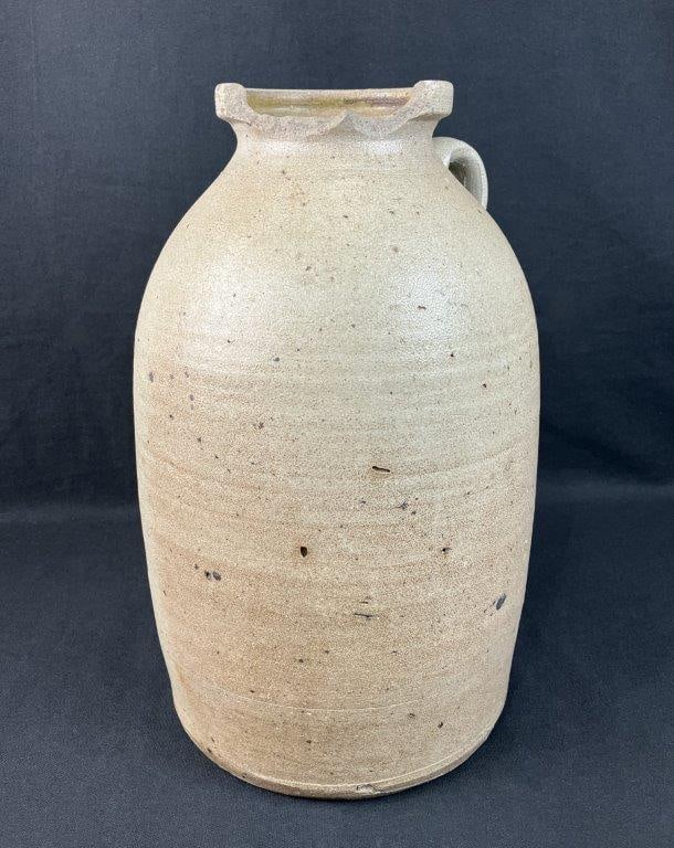 Salt-Glazed Stoneware Jar: Salt-glazed stoneware jar beautifully captures the rugged craftsmanship and tactile charm of early American utilitarian pottery. Characterized by its classic orange-peel textured natural surface and