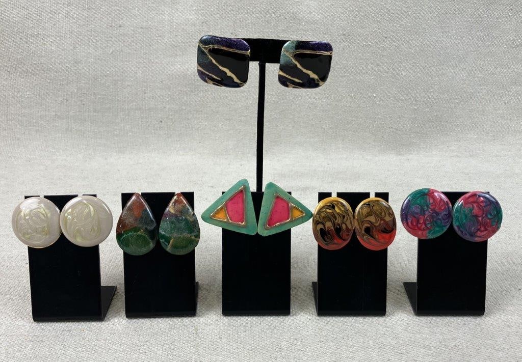 Group of Modernist Enamel Iridescent Earrings: Six pairs of modernist vintage stud earrings features statement-sized designs, many incorporating swirls of vibrant, iridescent enamel. One standout pair includes a square form with blue and green