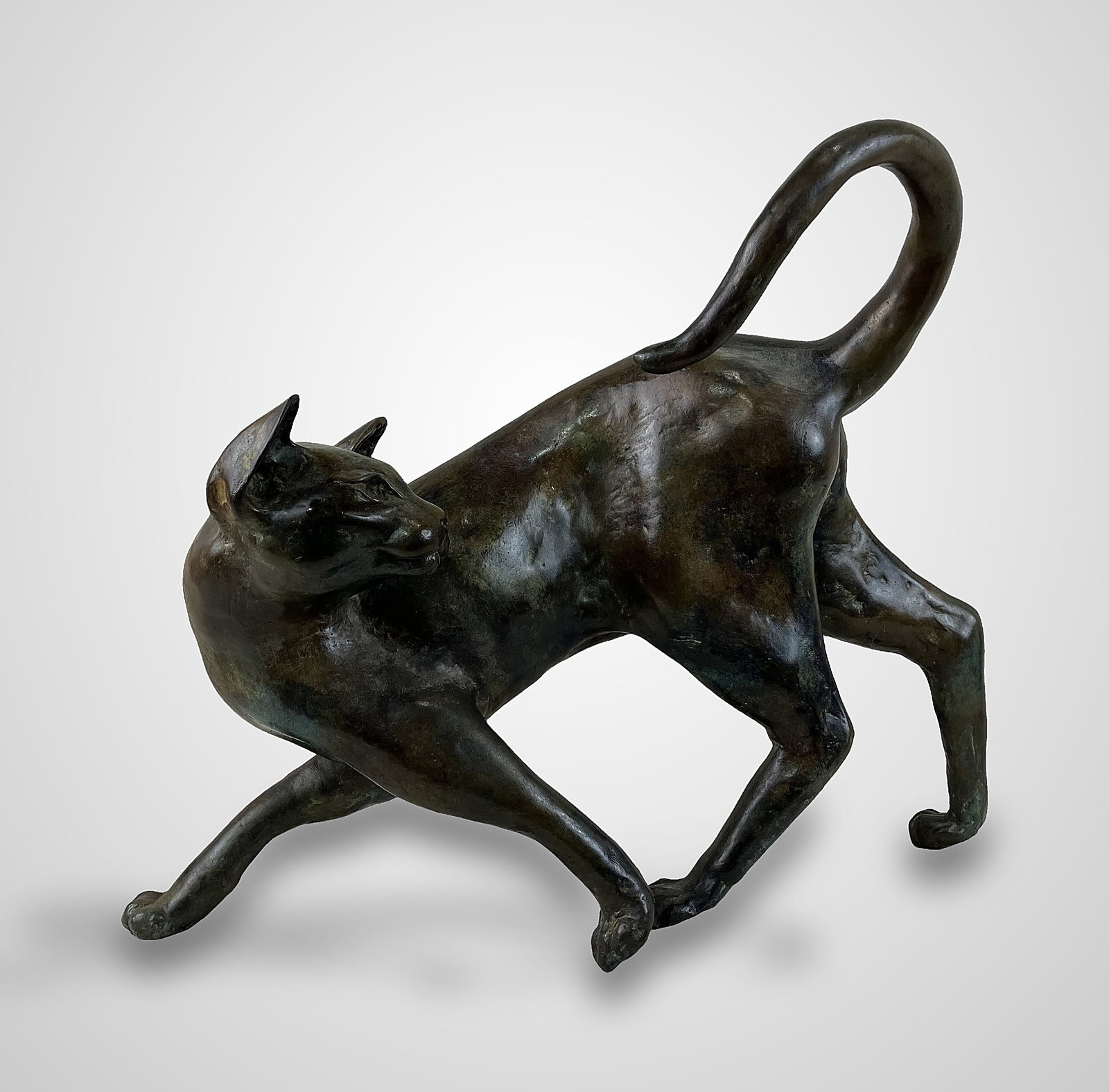 Tom Merrifield Cat Bronze Sculpture: Signed large and beautiful bronze casting features an elegant cat in a refined pose with a curled tail and a prancing form. Tom Merrifield (1932â€“2021) was an acclaimed Australian-bo