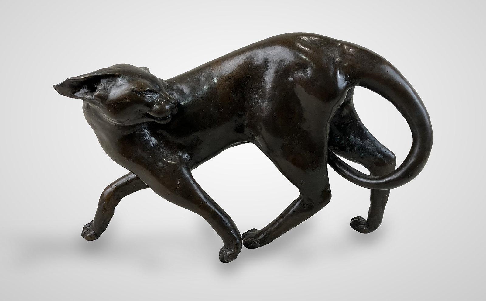 Tom Merrifield Cat Bronze Sculpture: Signed large and beautiful bronze casting features an elegant cat in a refined pose with a curled tail and a prancing form. Tom Merrifield (1932â€“2021) was an acclaimed Australian-bo