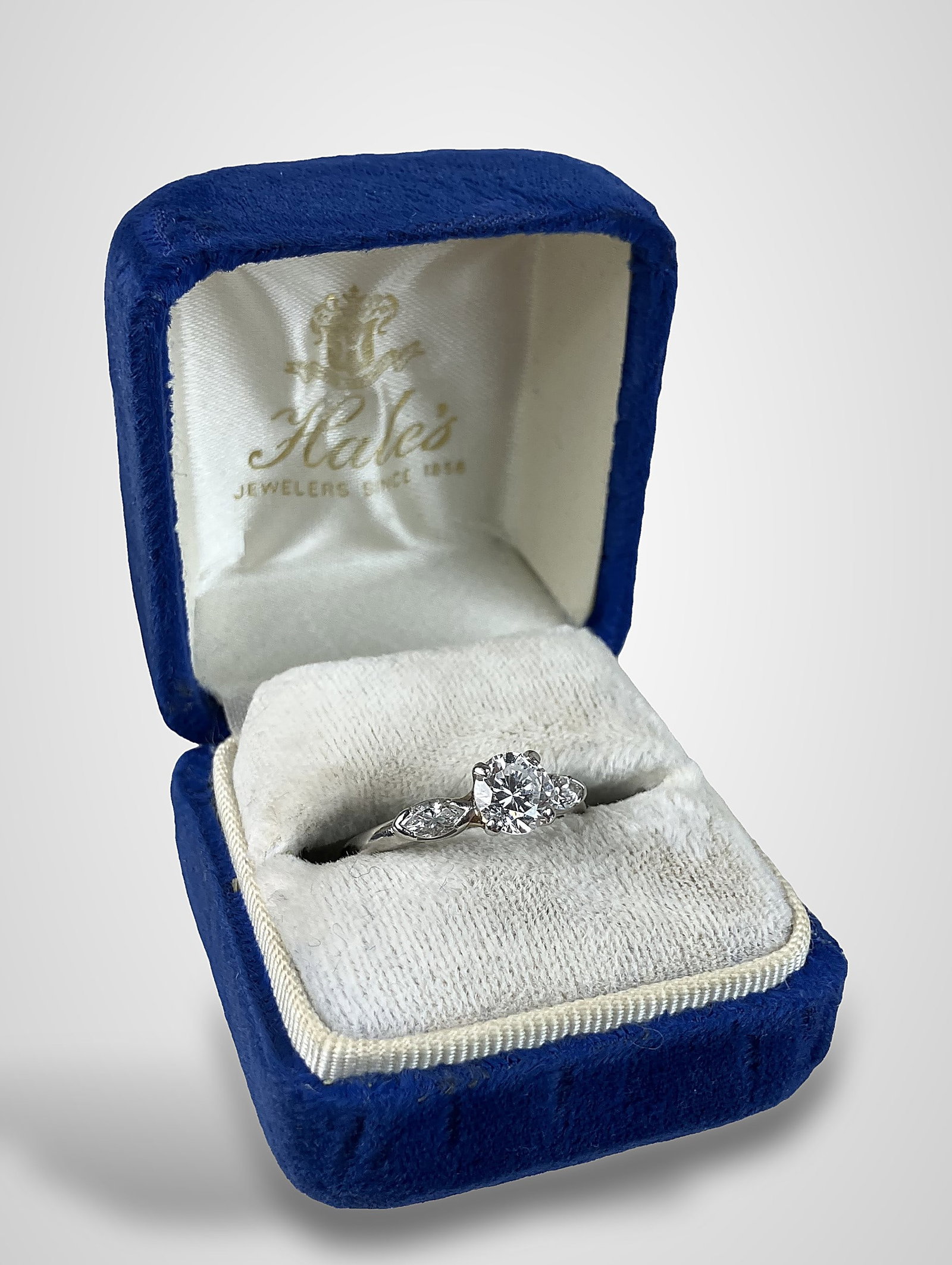 1 CT Diamond and Platinum Ring: Elegant ring features a 0.95 CT central round brilliant-cut diamond in a prong setting, flanked by two marquise-shaped brilliant-cut diamonds totaling 0.50 CT. The piece is a size 8 with a total weigh