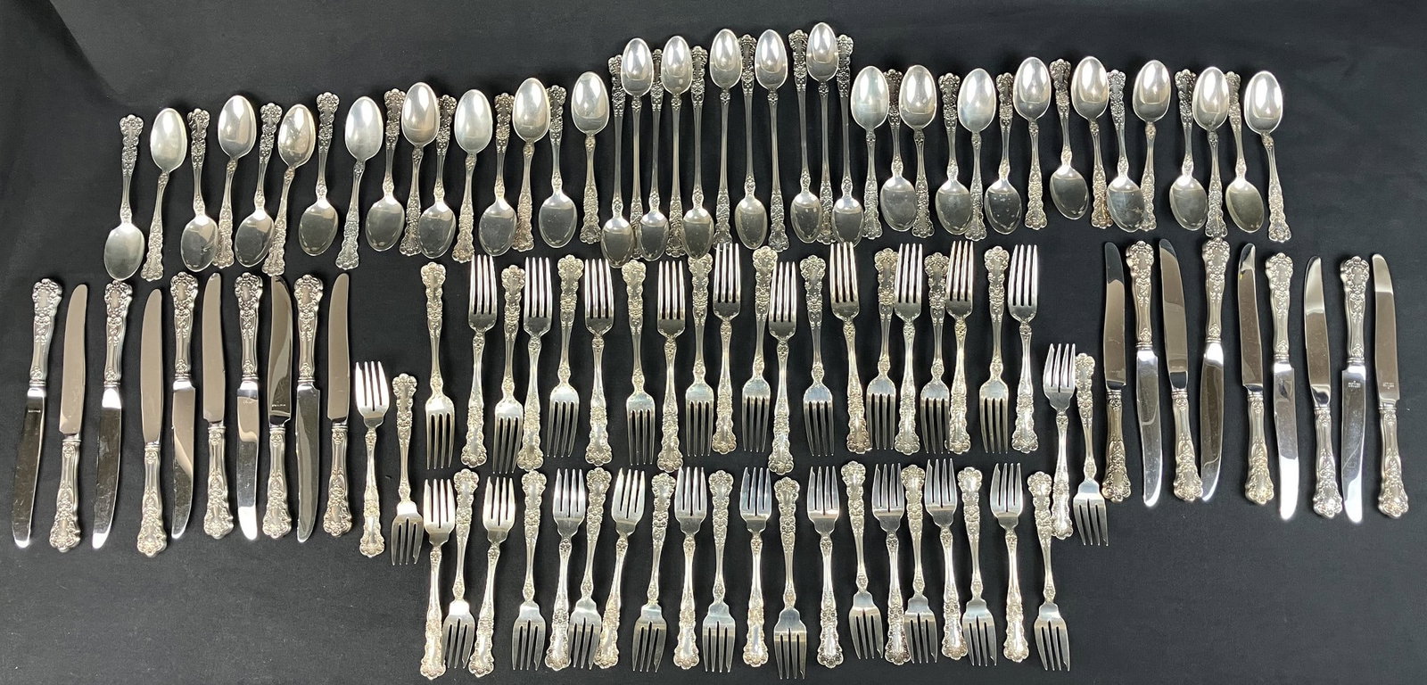 Gorham Buttercup Sterling Silver Flatware Set: This comprehensive 104-piece set is crafted in the Buttercup pattern, patented in 1900, and features the traditional Gorham mark (lion passant, anchor, and G). The set is marked for sterling silver