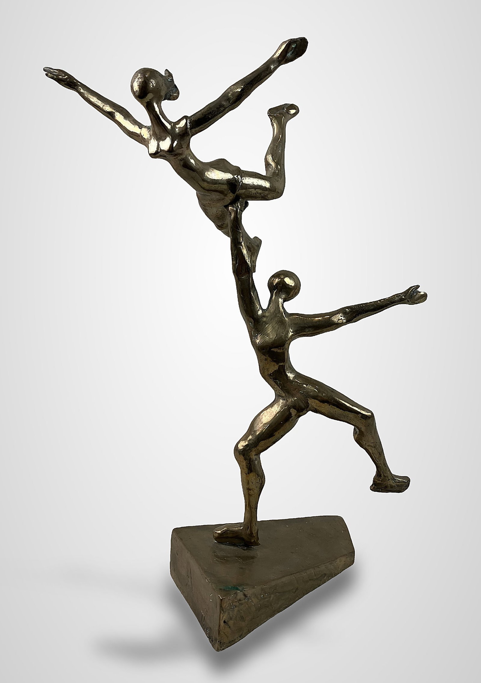 Theo Bronze Dancers Sculpture: Modernist sculpture features two dancers, with a male figure in the process of lifting an expert female dancer. Crafted in bronze with a gilt finish, the piece is signed "Theo" on the side. The