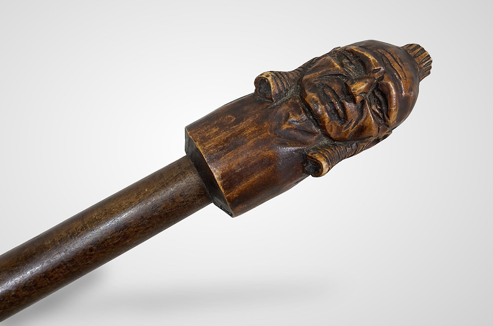 Signed Native American Folk Art Carved Cane: This folk art piece features a double-sided handle intricately carved with two Native American faces. It is signed "Boggs" and dated 1978. Measuring approximately 39 1/2 in. L x 2 1/4 in. W, the cane
