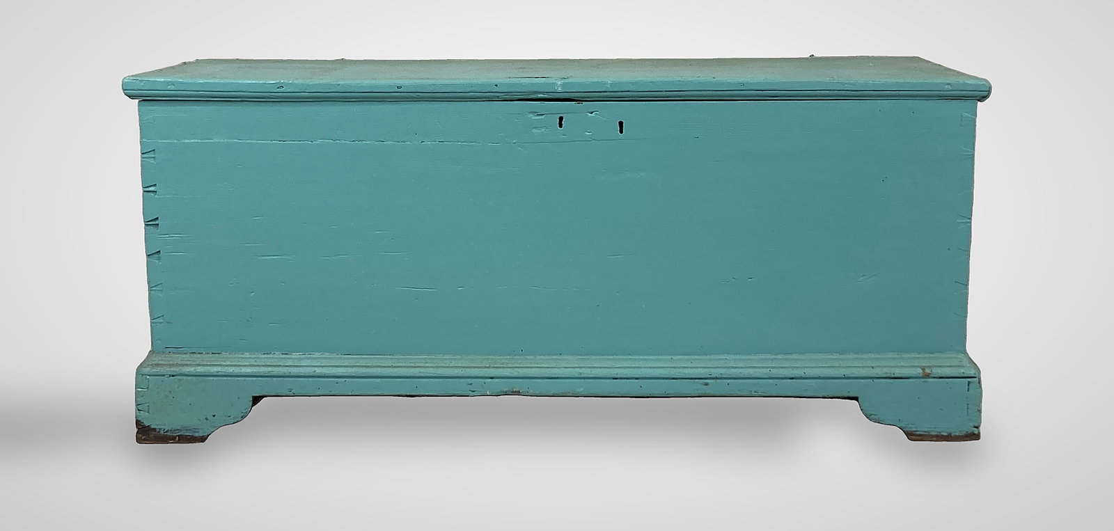 Painted Blanket Chest: Piece features classic dovetailed construction and is elevated by sturdy bracket feet. It is finished in a distinctive aqua or turquoise paint. It measures 21 in. H x 48 3/8 in. W x 18 1/8 in. D and