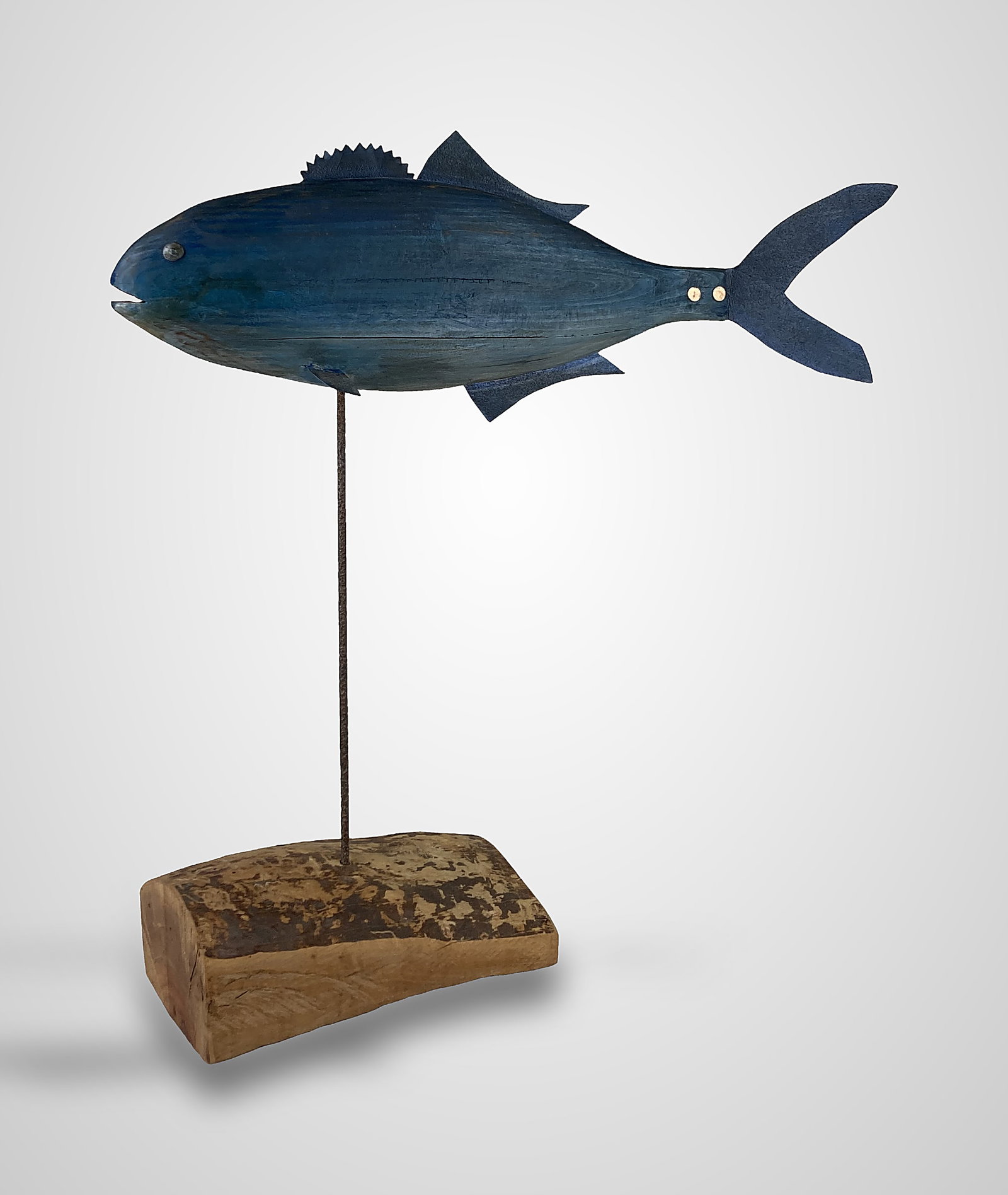 Polychromed Folk Art Tuna Sculpture: This hand-carved sculpture features a solid sculpted wood body accented by metal dorsal finlets, side fins, and a tail fin, the latter of which is secured to the body with two metallic rivets. The