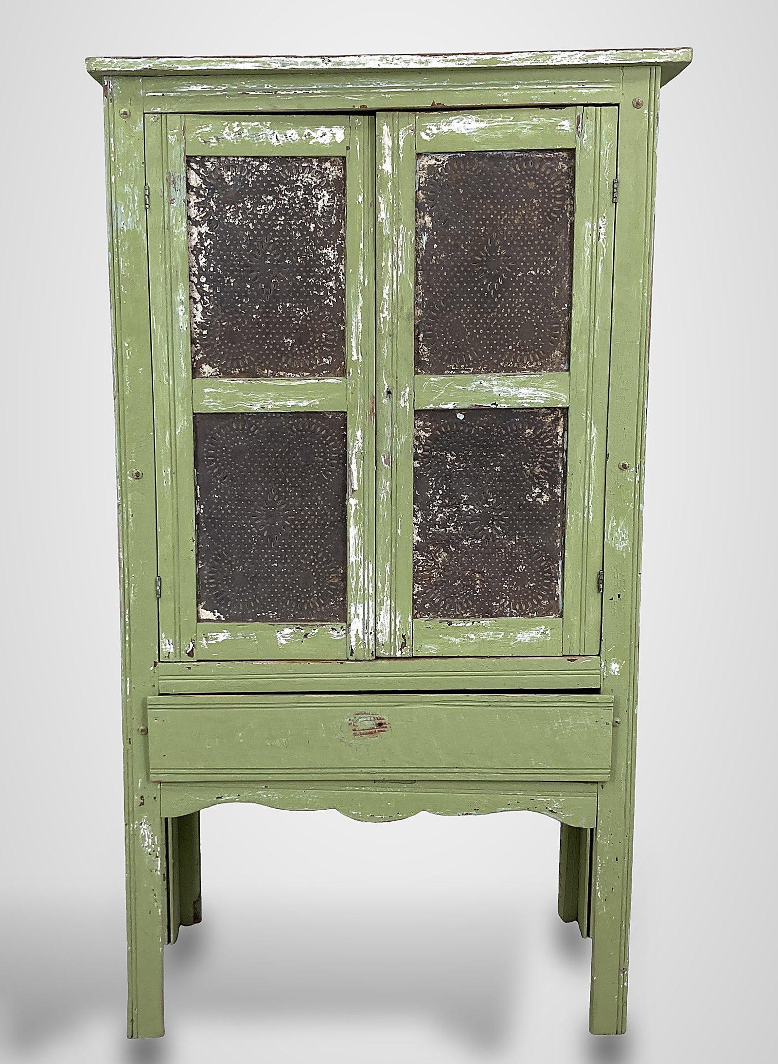 Country Painted Pie Safe: piece features classic punched tin panels and is finished in a charming, worn light green paint with muted lime tones. It includes a lower drawer, a shaped apron, and raised feet. The pie safe