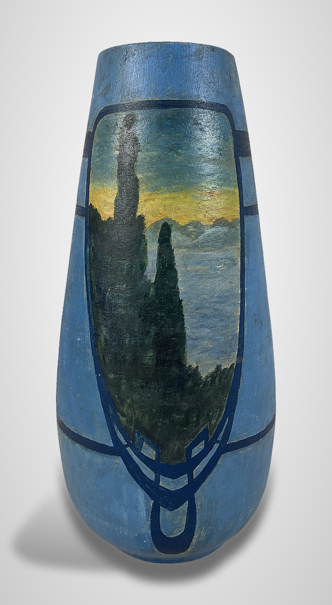 Arts and Crafts Decorated Vase: Wheel-thrown studio pottery vase features hand-painted landscape scenes on both sides, depicting scenic trees and mountainside views set within painted frames. The artwork is framed by linear light