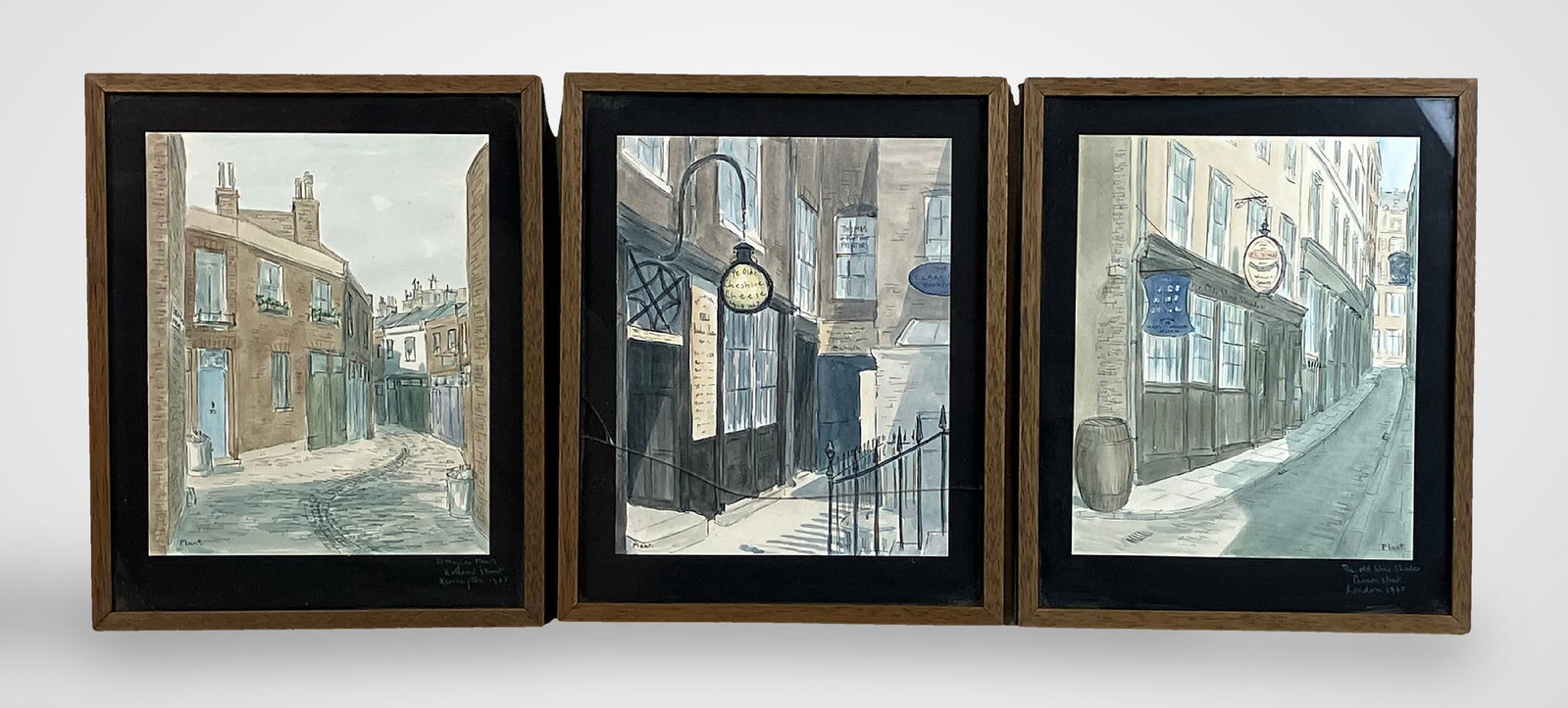 Three Pamela Plant English Cityscape Watercolors: Trio of watercolors by 20th-century British artist and former actress Pamela Plant includes depictions of Cannon Street in London, a street corner featuring a cheese shop and bookstore, and Holland