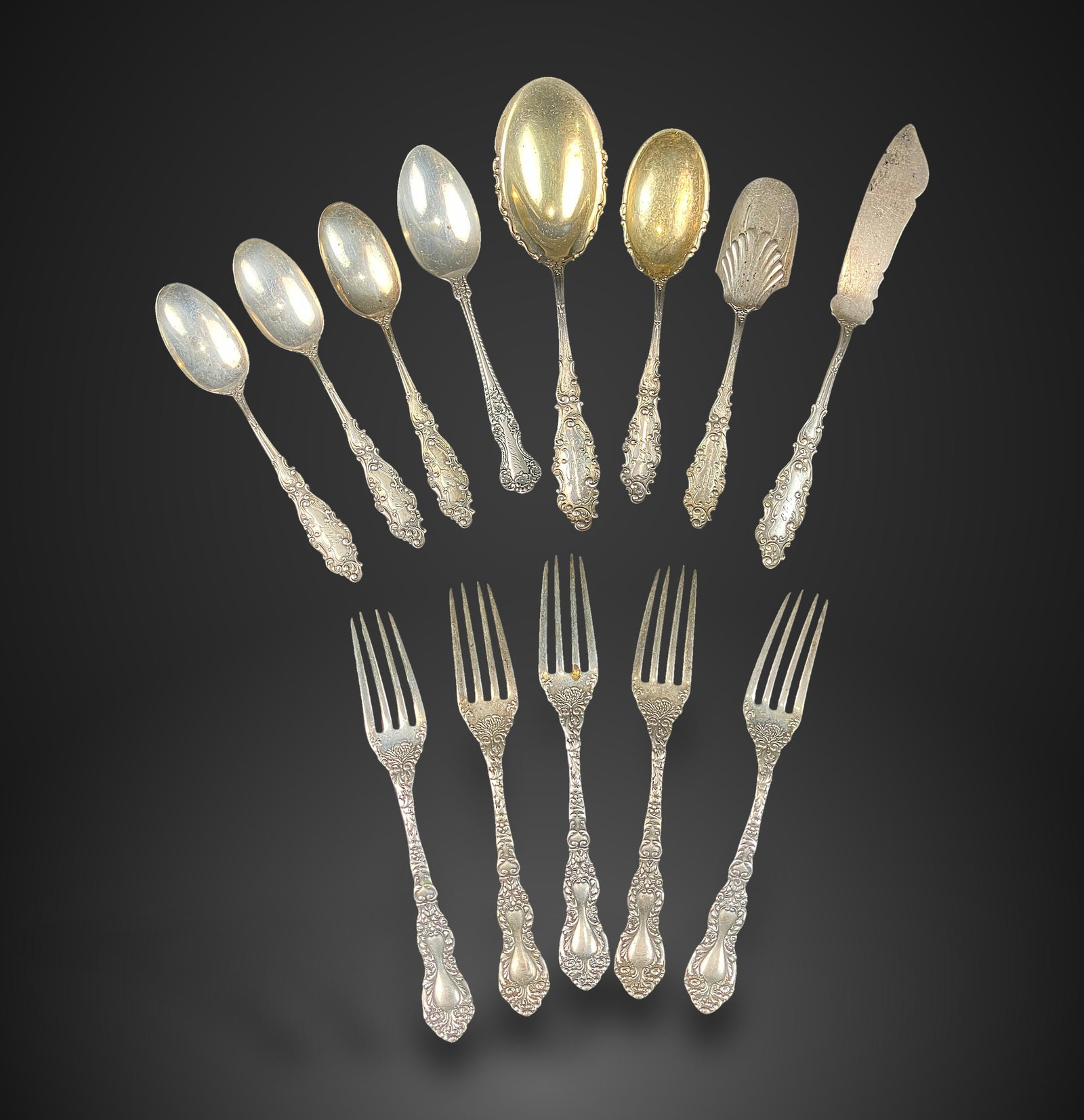 Gorham Sterling Silver Flatware Assortment: 13-piece collection is crafted in the Luxembourg pattern, featuring the Gorham mark (lion passant, anchor, and G) and markings for sterling silver content. The set includes a sugar spoon, a cheese