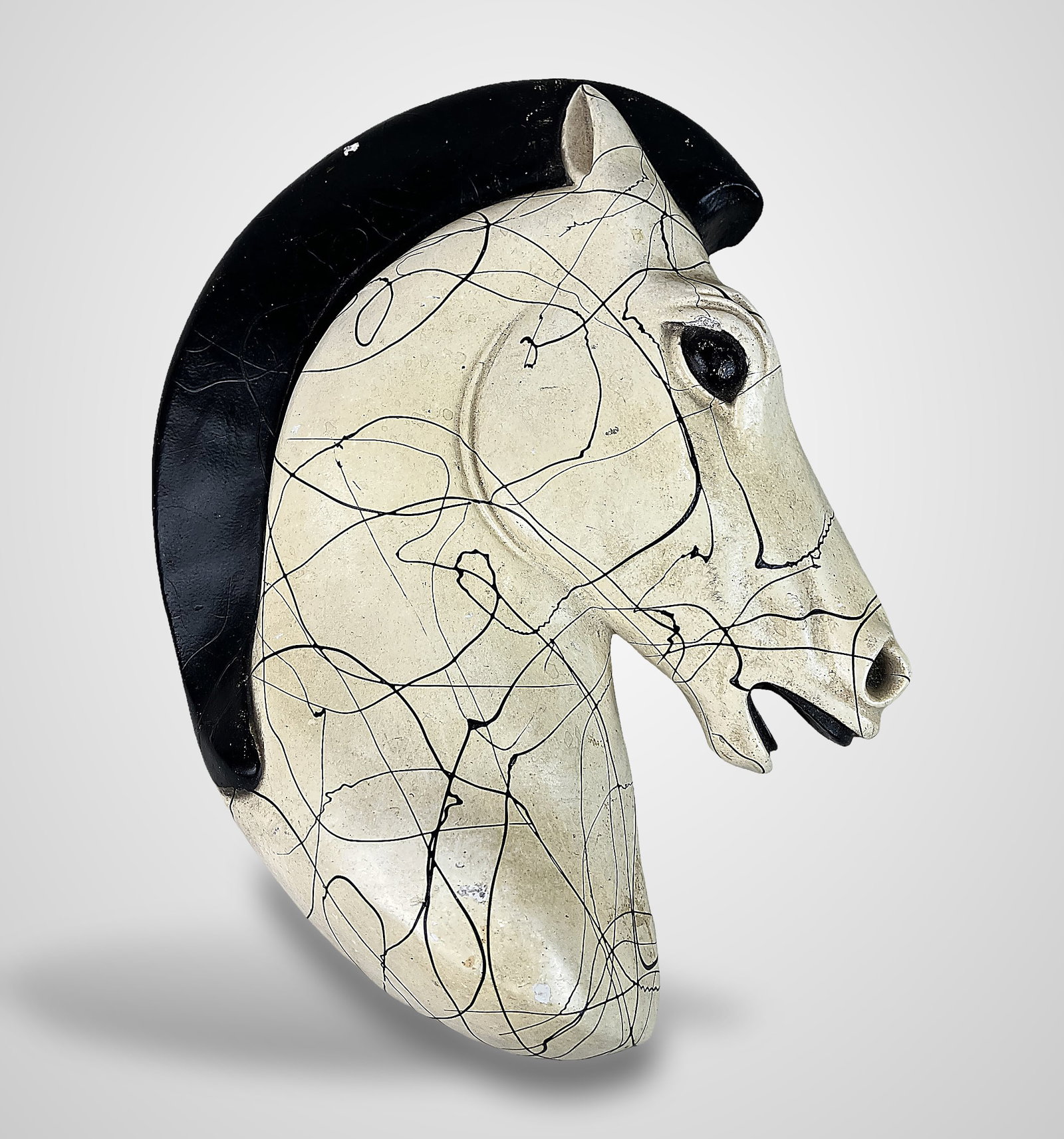 Mid-Century Modern Chalkware Horse Head: This wall-mounted horse head plaque features creamy beige tones accented by splatter-style detailing inspired by Jackson Pollock, complemented by a bold black mane. It measures approximately 8 1/2