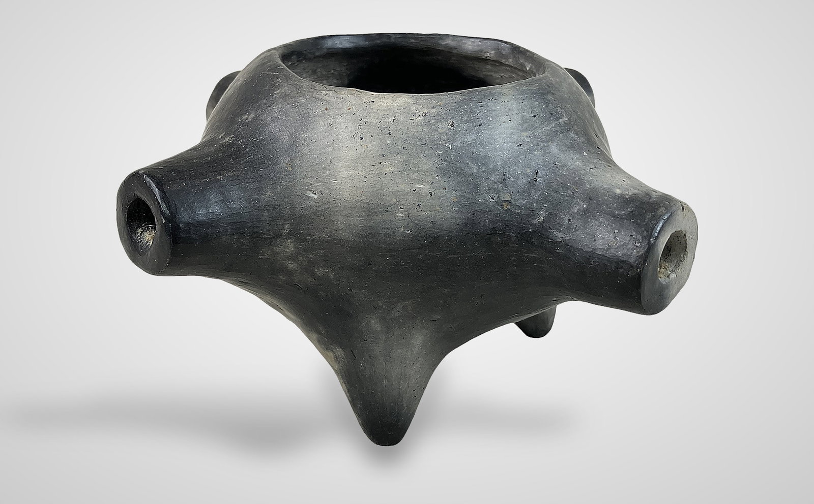 Catawba Indian Pipe Bowl by JoAnn Bauer: Traditional, hand-built earthenware piece was crafted by JoAnn Bauer, a respected artisan from the Catawba Indian Nation in South Carolina. Featuring multiple openings, the bowl has been pit-fired to