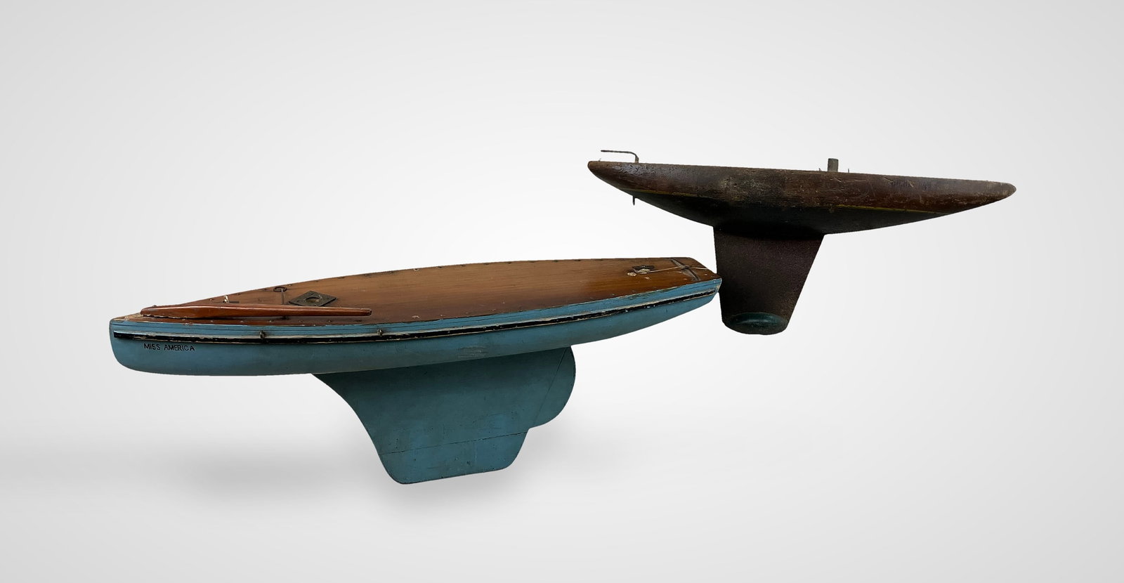 Two Model Sailboats: Two handcrafted model sailboats are presented as bases suitable for a hobbyist or artist to build upon; the larger blue example is named Miss America and measures approximately 8 5/8 in. H x 23 3/8