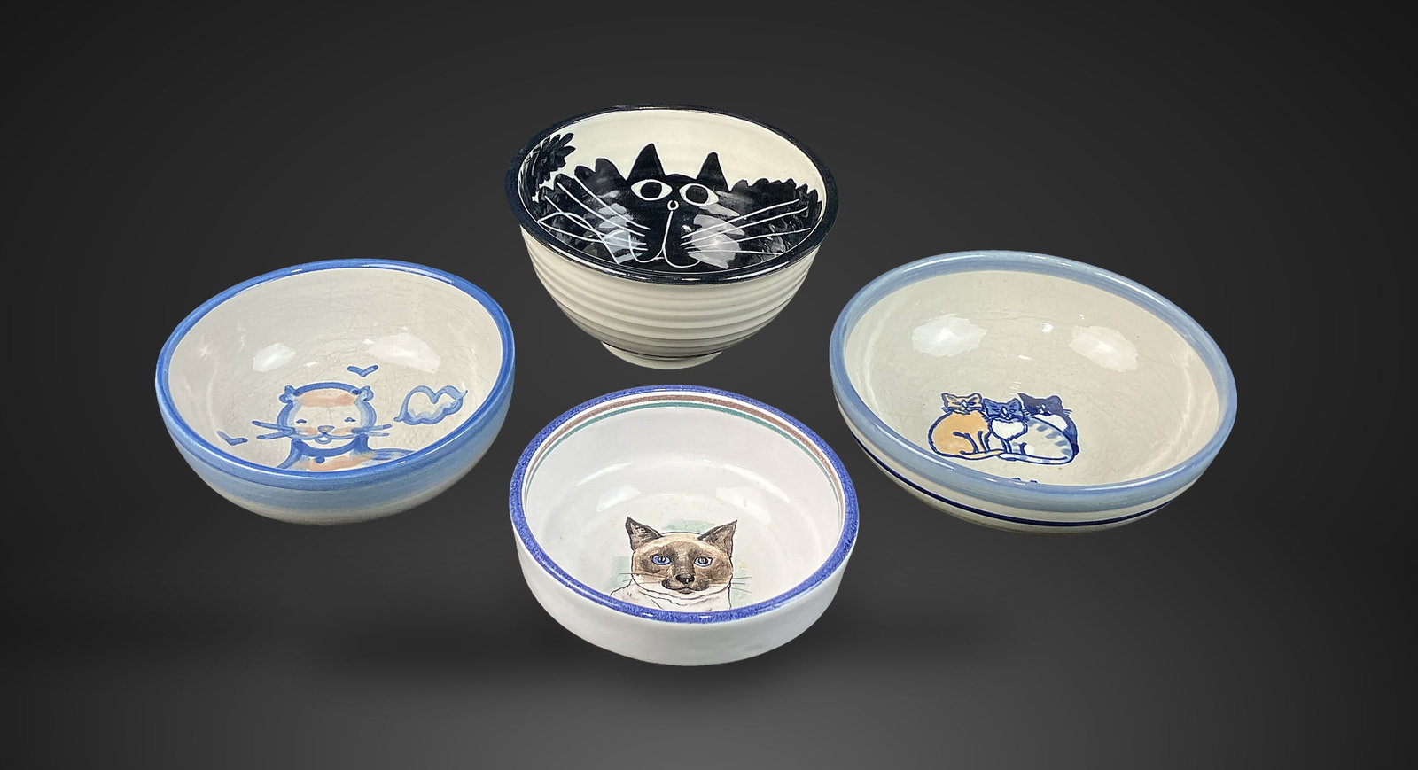 Cat-Decorated Studio Pottery Bowls: Group of four bowls features charming cat motifs and includes pieces by M.A. Hadley and Louisville Stoneware. Louisville Stoneware is recognized as one of the oldest continuously operating pottery
