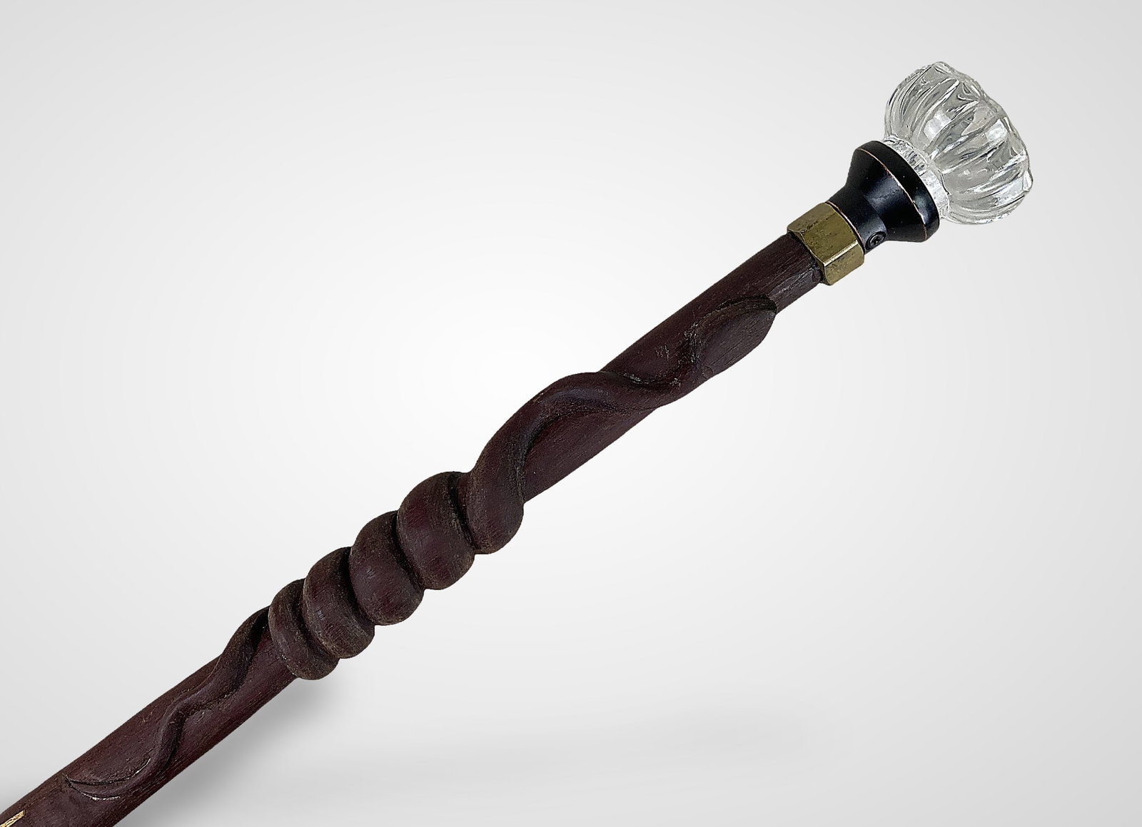Carved Folk Art Snake Cane: This unique hand-carved wood cane features a relief-carved snake winding tightly around the shaft. The design utilizes a multi-point joint to splice a dark top section with a lighter lower section.
