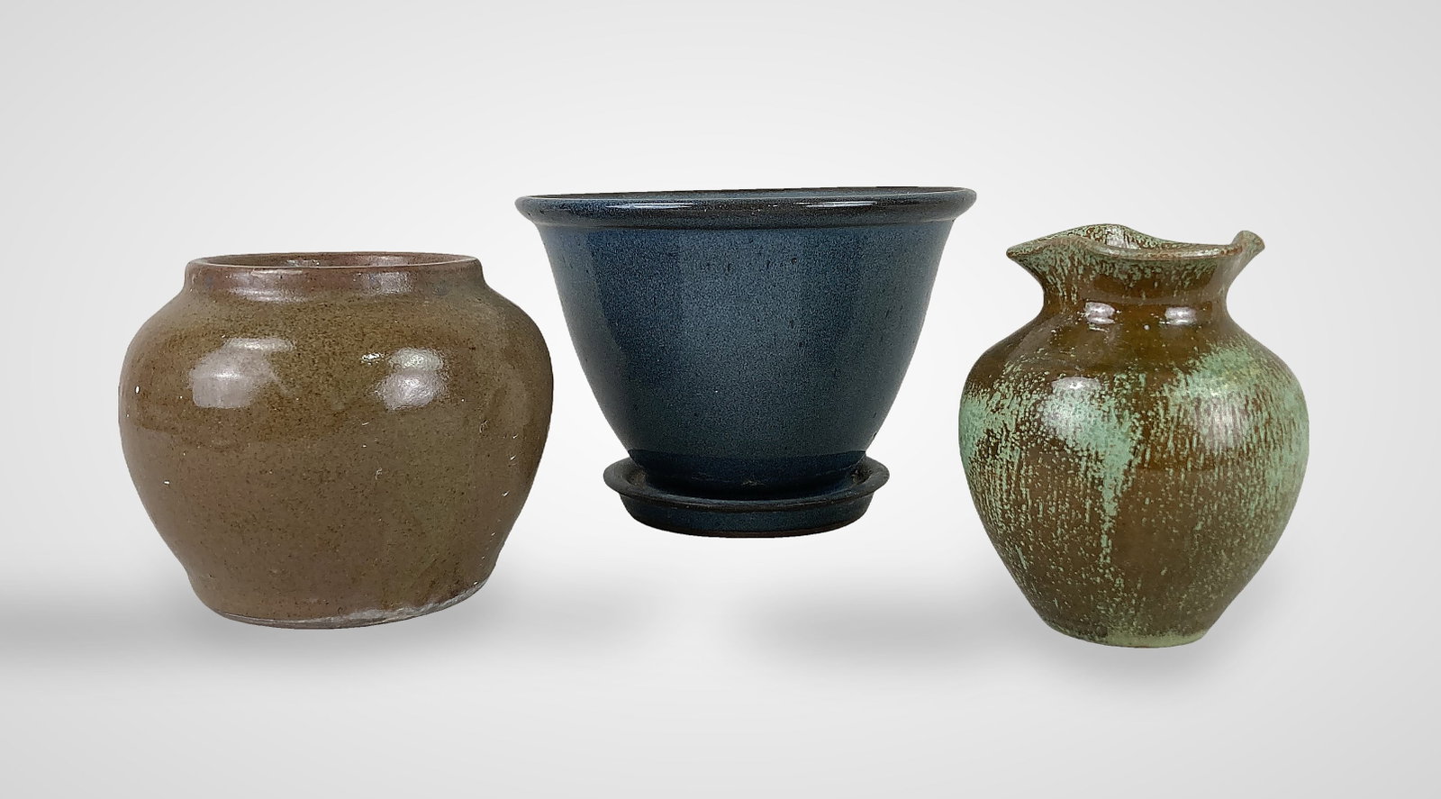 Studio Pottery Vessels Including Brown and Jugtown: Three American studio pottery vessels including a wheel-thrown Jugtown Ware planter, a squat ovoid jar by Brownâ€™s Pottery of Arden, NC, and a small ovoid vase. The Jugtown planter f