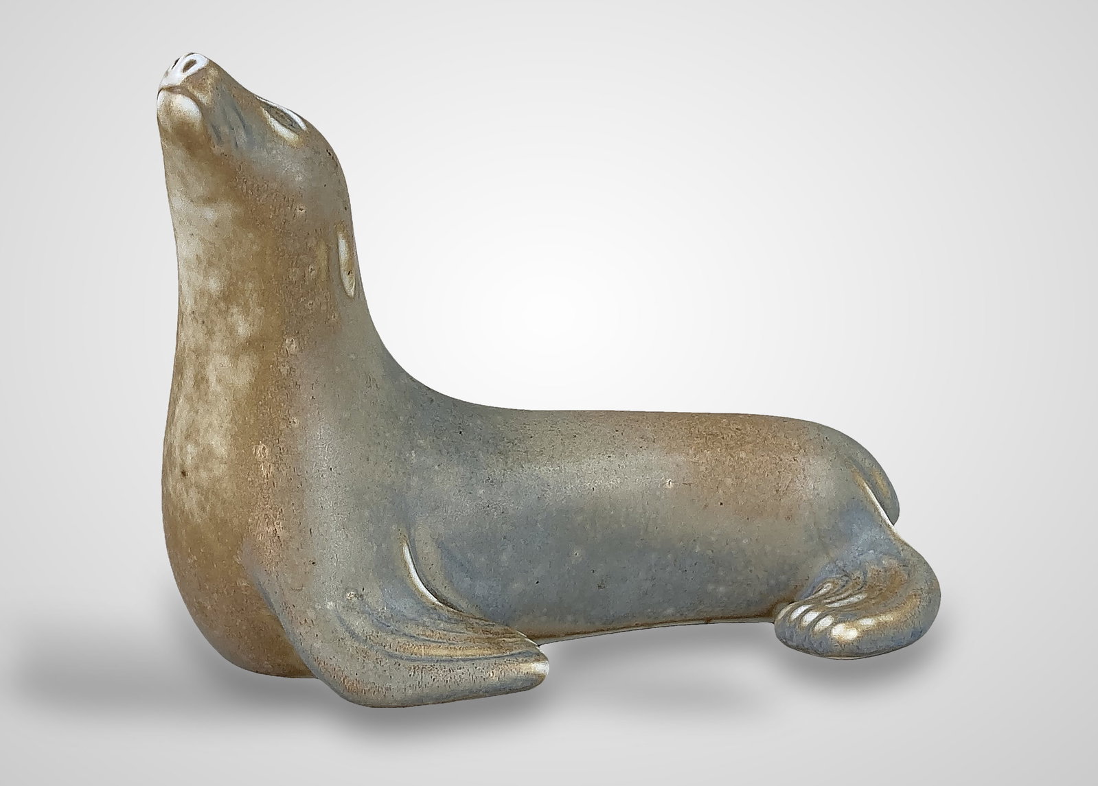 Gunnar Nylund Ceramic Seal Figure for Rorstrand: This mid-century modern ceramic figurine was designed by the renowned artist Gunnar Nylund (1904â€“1997) for the Swedish manufacturer RÃ¶rstrand. The piece features a