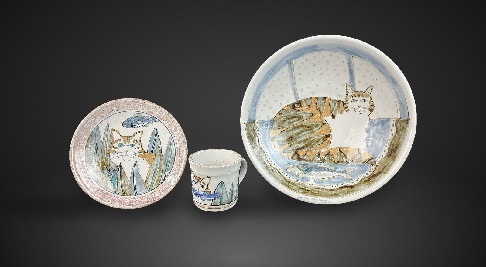 Highland Stoneware Cat Pottery: Set includes a mug, a salad plate, and a large bowl, each piece featuring skillful, hand-painted cat motifs. Highland Stoneware is an internationally renowned Scottish manufacturer established in 1974