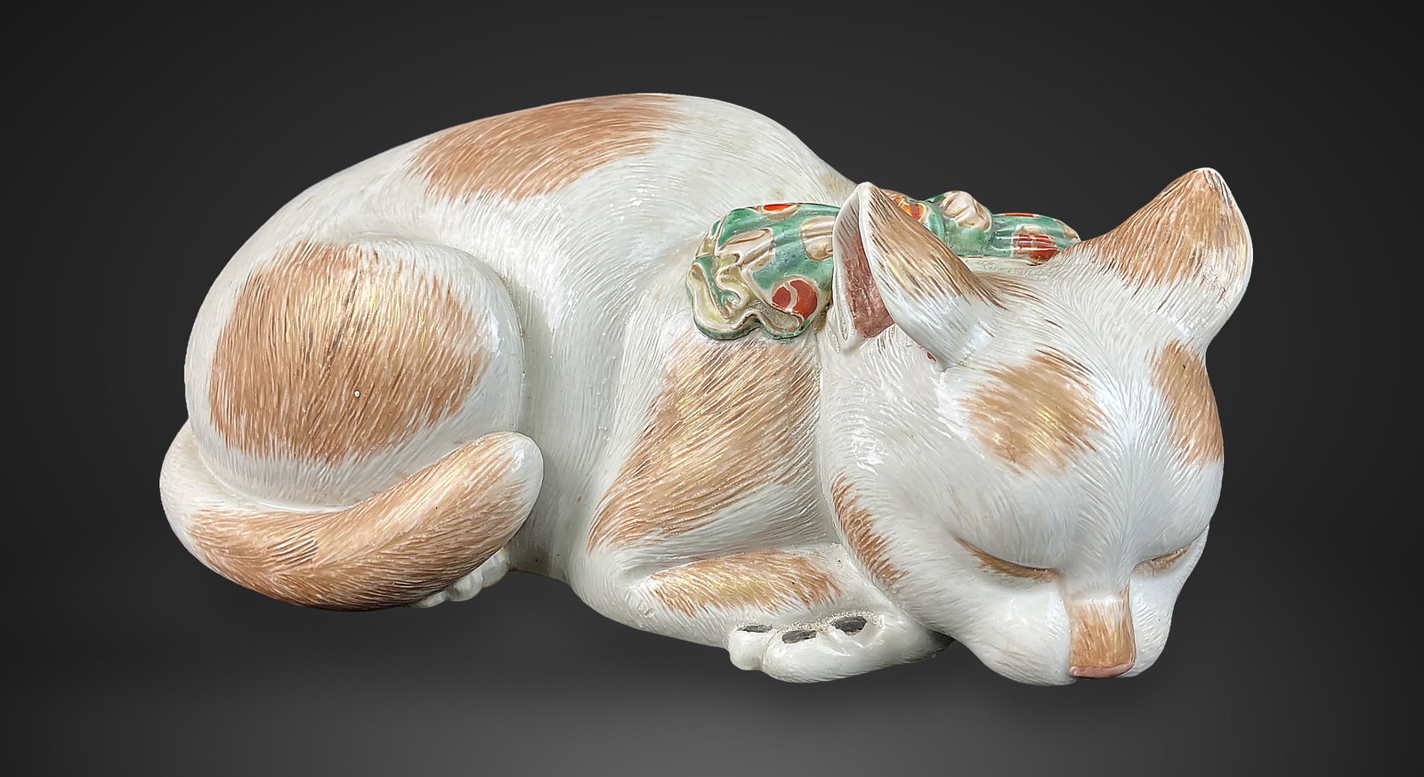 Japanese Kutani Cat Figurine: Exquisite medium-size figurine is executed in the classic Japanese Kutani manner, featuring intricate hand-painting and delicate gilt details. It showcases fine brushwork to define the fur,