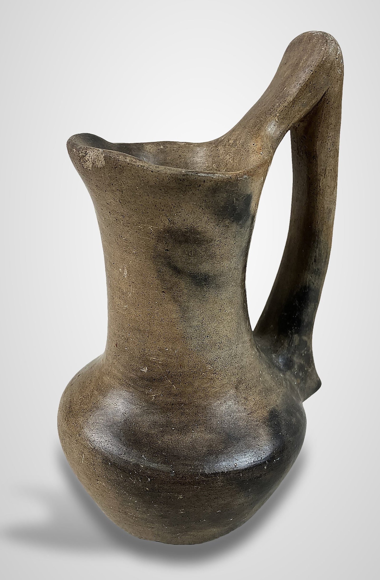 Catawba Indian Pitcher: Traditional, hand-built earthenware pitcher showcases Native American artistry, featuring a Rebecca style design characterized by delicate proportions, a strongly curving body, and a gracefully