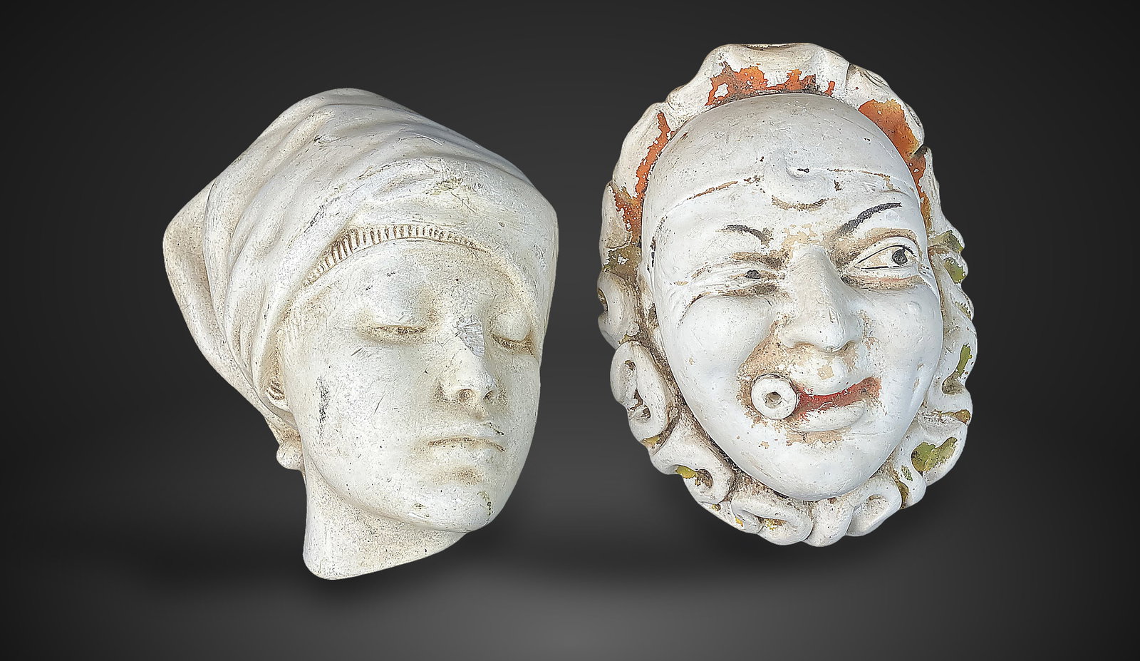 Two Chalkware Busts: features a striking contrast in character and style. One bust depicts a clown or jester with a winking eye, cigar, and bold orange paint; the second depicts a young girl with a serene facial