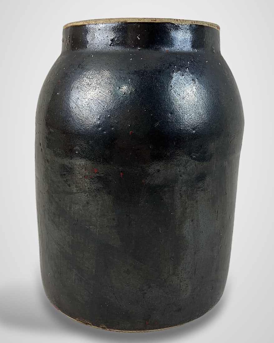 Small Albany Slip Stoneware Storage Jar: Storage jarâ€”or small crockâ€”features a rich brown Albany slip glaze, a slightly curving shoulder, and a recessed lip designed to accommodate a cover. It measures