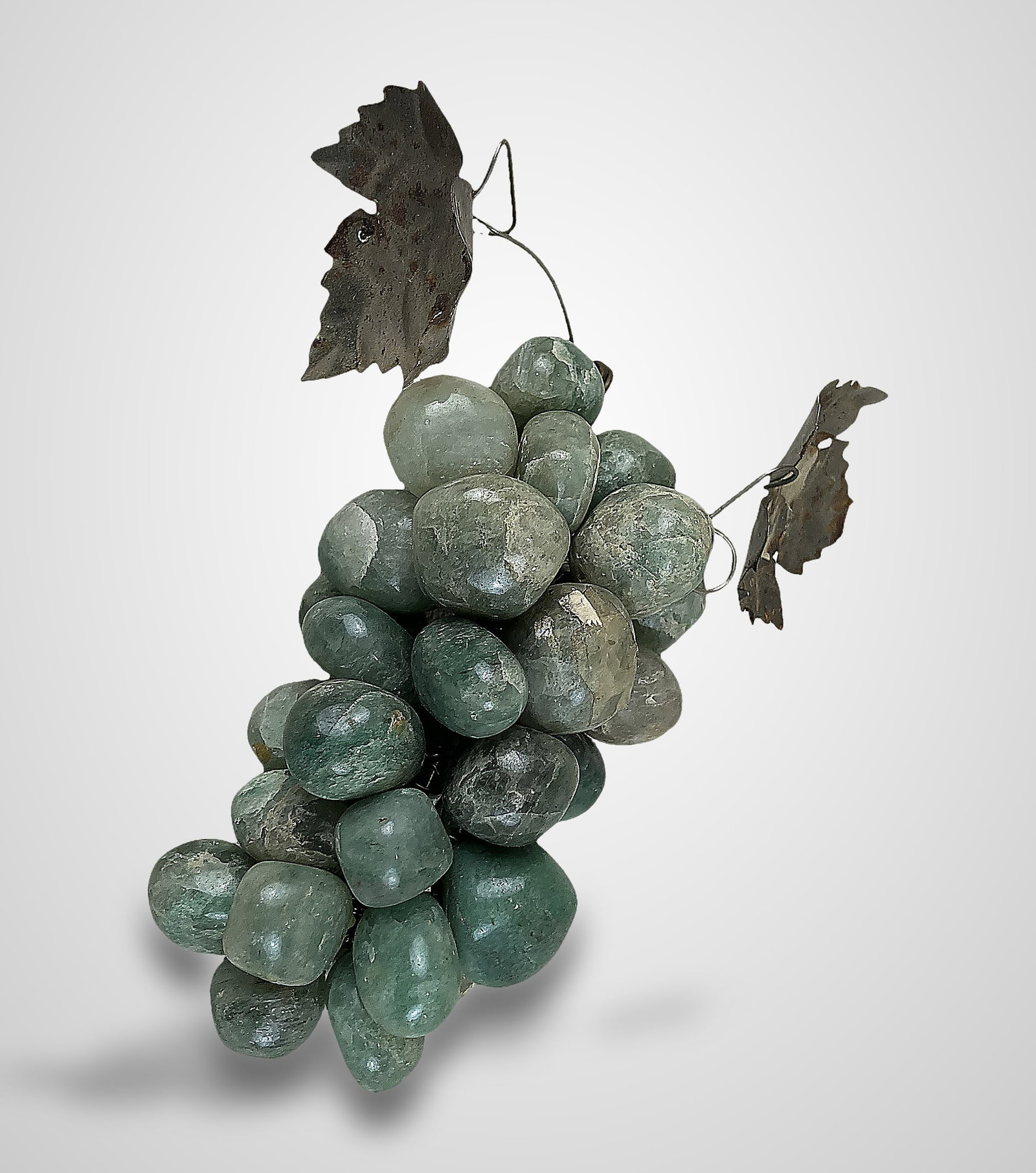 Stone Grapes: Decorative cluster features polished green aventurine grapes accented with metal leaves. The piece measures approximately 5 in. H x 3 3/4 in. in diameter including the leaves. While the stones are in 