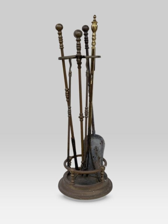 Brass Fireplace Tool Set: Elegant brass fireplace tool set, each implement featuring a graceful form topped with a round finial, housed within a coordinating brass stand; the stand measuring approximately 24 7/8 in. H x 7 in. 