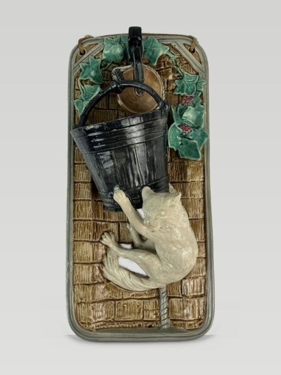 T.C. Brown-Westhead Ceramic Cat Wall Pocket: This ceramic wall pocket, produced by T.C. Brown-Westhead, features a white cat attempting to climb into a dark bucket, set against a background designed to look like a brown brick wall with green
