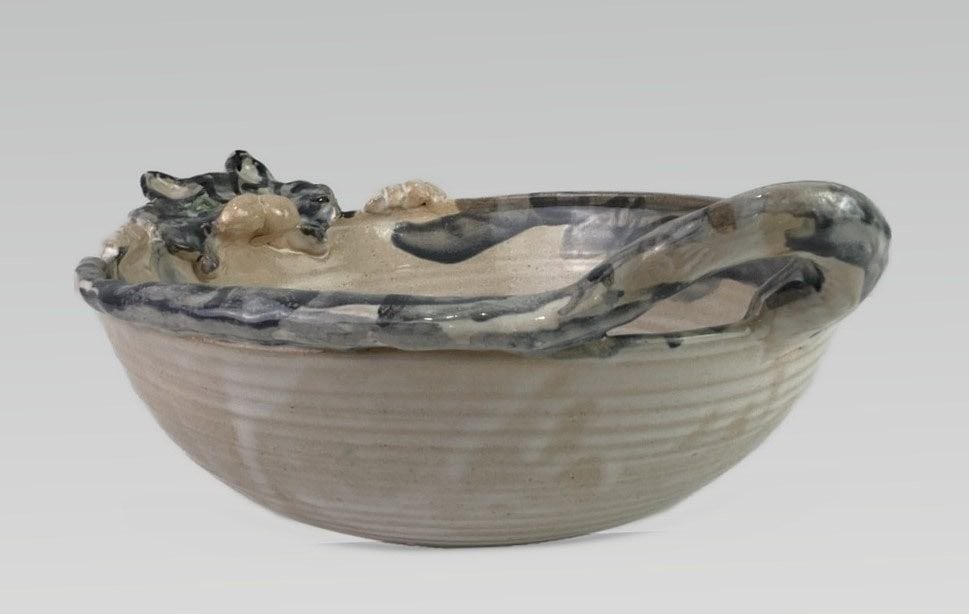 Figural Cat Studio Pottery Bowl: Wheel-thrown studio pottery bowl features a light glaze and is distinguished by charming figural elements, with the lip and handles formed by a cat's head, tail, and paws. Signed by the artist to the