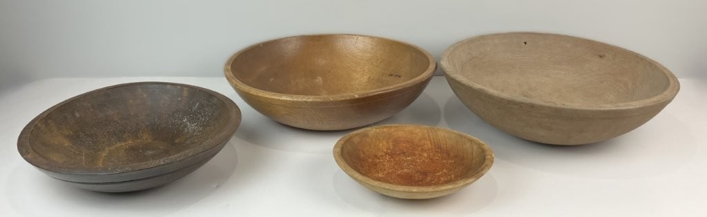 Four Country Dough Bowls: This collection of four turned country wooden dough bowls showcases traditional wood-turning expertise, each featuring a classic rounded profile and a rich, deep patina built from age and use.