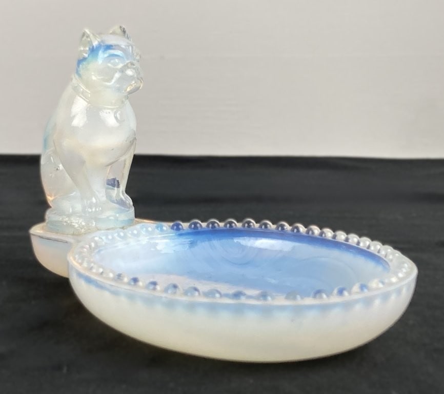 Sabino French Bulldog Art Glass Dish: This exquisite art glass piece features a shimmering opalescent glass dish crowned with an attached French Bulldog figure and finished with a delicate beaded rim. The underside is marked "France,"