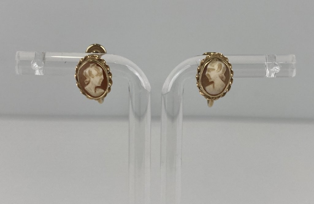 14KT Gold Cameo Screw-Back Earrings: Exquisite screw-back earrings are crafted in 14-karat yellow gold and bear hallmark stamps alongside maker's marks for the renowned J.M. Fisher Company, with gold content verified by testing. Each