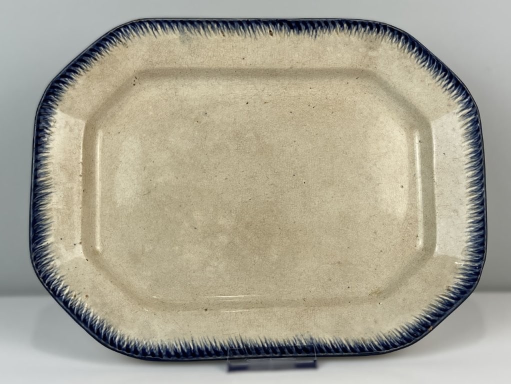 Leedswear Feather Edge Platter: Early 19th century platter features the classic embossed and cobalt-decorated scalloped border characteristic of traditional feather edge patterns. The octagonal piece showcases clean lines and a