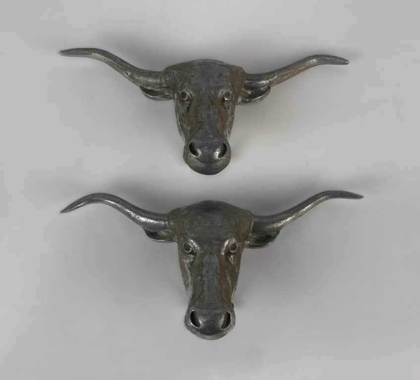 Pair of Bruce Fox Texas Longhorn Steer Head Castings: Striking pair of mid-century metal cast sculptures were designed by renowned metalsmith Bruce Fox of Mount Joy, Pennsylvania. Executed in durable cast aluminum with a distinctive silvery finish. Origi