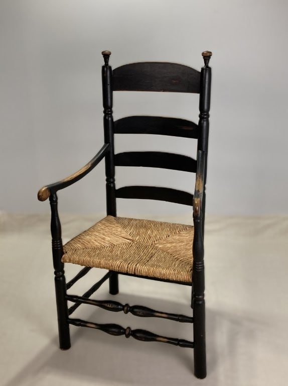 Early 19th-Century Country Armchair: Substantial early 19th-century country armchair (circa 1820â€“1840) features a classic ladder-back construction with gracefully curved horizontal splats, shaped armrests, turned