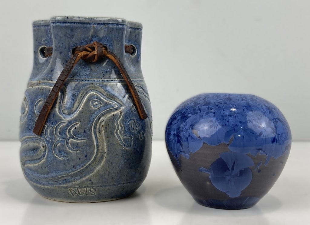 Phil Morgan and John Neis Pottery Vessels: Two studio pottery vessels displaying an ovoid-form vase showcasing a blue crystalline glaze against a grey background, signed "Phil Morgan" and dated 1988 on the base, alongside a stoneware vase by