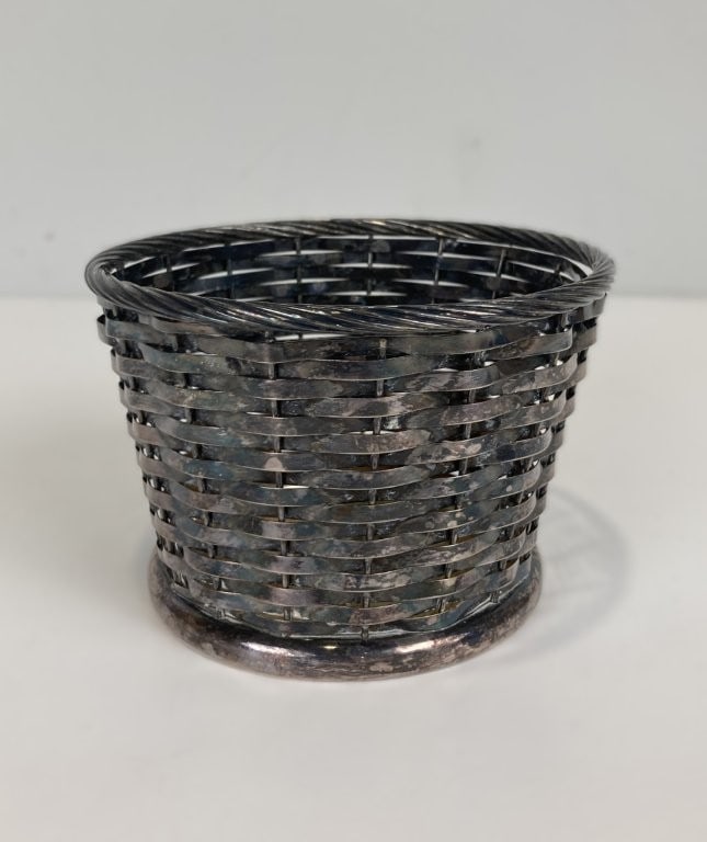 Gorham Silverplate Woven Basket: Charming mid century silverplate basket by Gorham features a delightful woven basket form crafted with a luminous, reflective silverplate. It measures approximately 3 3/8 in. H x 4 5/8 in. in