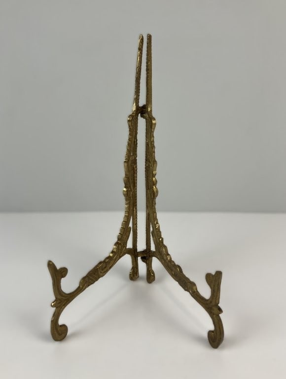 Cast Brass Tabletop Picture Easel: Tabletop picture easel is crafted from solid cast brass, featuring intricate openwork scroll design and a sturdy, dimensional folding structure designed to display fine photographs, plates, or small